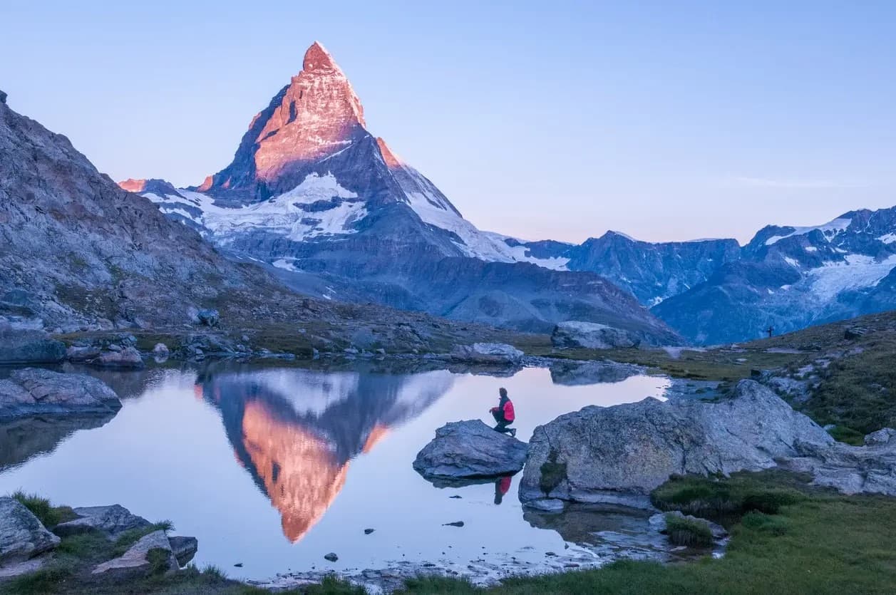 Matterhorn peak reflecting in alpine lake at sunrise